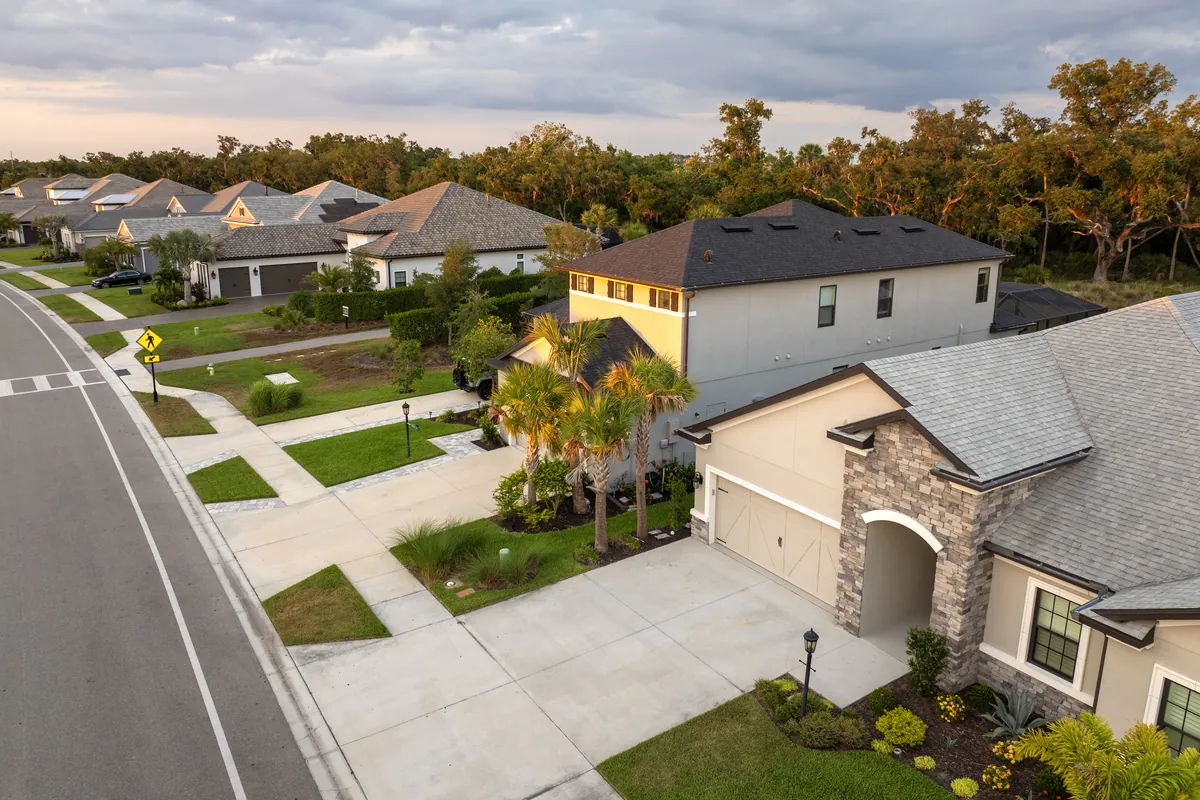 Quiet street of single-family homes with landscaped front yards in a planned community